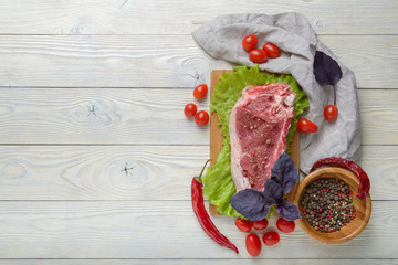 Wall Mural - raw meat with ingredients on a wooden background