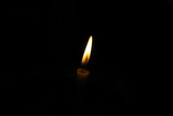 Fototapeta  - Candle light on black background