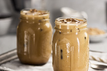 Two Glass Jars Of Cold Iced Coffee With Cream