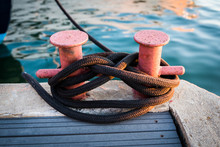 Mooring Bollard With Rope On Pier By The Sea.