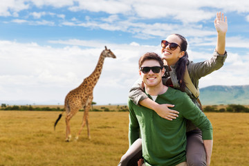 happy couple with backpacks having fun in africa