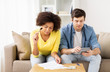 © Syda Productions - couple with papers and calculator at home