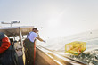 © Daniel Grill Images/Tetra Images - Fisherman working on fishing boat
