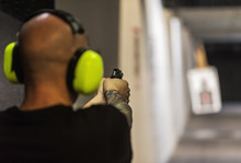 Man Shooting Gun At Shooting Range
