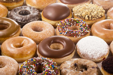 Background Of Assorted Donuts (Doughnuts) Of Various Flavors
