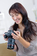 © auremar - happy woman photographer takes images with dslr camera