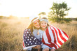 © MeganBetteridge - Patriotic mother and daughter with American flag