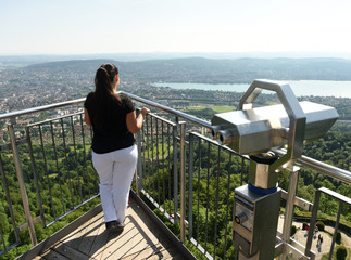 Wall Mural - Female tourist enjoying cityscape of Zurich view from Uetliberg, Switzerland.