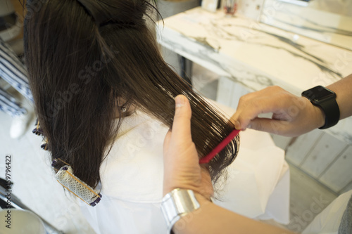 A Woman Is Putting A Perm In A Hair Tip At A Hair Salon Buy This