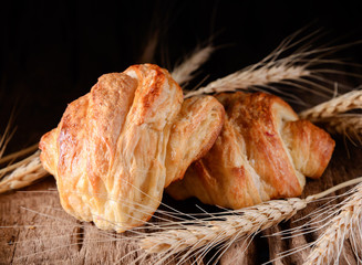 Wall Mural - Tasty croissants on wooden background.