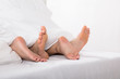 © Andrey Popov - Couple's Feet On Bed