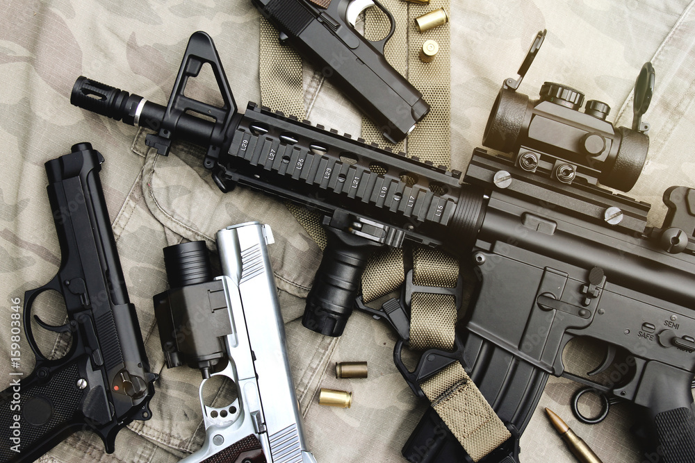 Weapons and military equipment for army, Assault rifle gun (M4A1) and pistol on camouflage background. - obrazy, fototapety, plakaty 