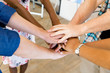 © Sergey Nivens - Top view of young people putting hands together