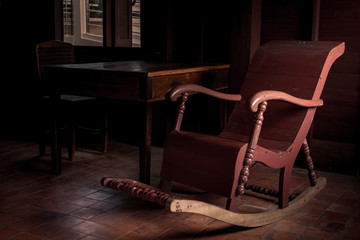 Brown rocking chair and side light