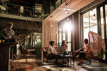 Creative business people taking a break in social room