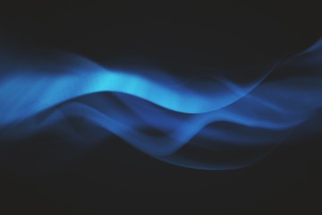 Wall Mural - blue waves on black background