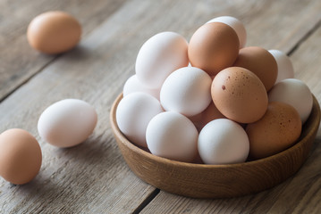 Wall Mural - Wooden bowl of raw chicken eggs