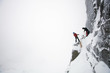 climbers on steep cliff during blizzard
