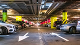 Fototapeta Góry - Modern, organized underground car parking garage. Perspective view. High-tech architecture
