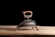 © Flowphoto - vintage flat iron on a wooden table