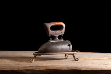 vintage flat iron on a wooden table