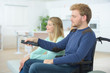 © auremar - Couple watching television, man in wheelchair