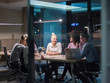 © .shock - Multiethnic startup business team in night office