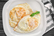 © Africa Studio - Delicious over hard eggs with basil leaves on plate