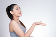 © 88studio - asian healthy athletic sporty girl woman in gray top throwing up something in the air with studio shot white background