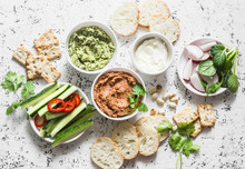 Vegetarian Dip Table. Eggplant, Harissa, Walnuts Dip, Broccoli Dip, Soft Tofu And Fresh Vegetables On A Light Background, Top View. Flat Lay