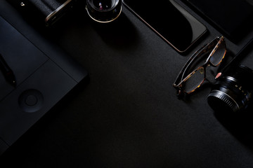 Designer desk mockup. Desk, Camera - Photographic Equipment, Smart Phone on dark top table.