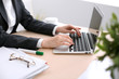 © rogerphoto - Close up of business woman  hands  typing on  laptop computer in the white colored office.