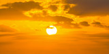 Fototapeta Zachód słońca - Sun shining through the clouds at sunset