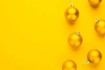 Christmas tree decoration balls on yellow background with copy space