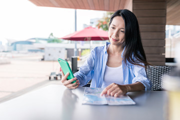 Sticker - Woman use of smart phone with city map in coffee shop