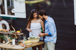 © Nena - Couple at barbecue party cooking salad