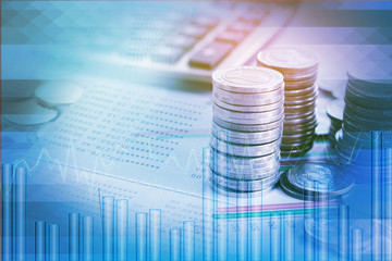 double exposure pile of coins,financial graph,stock chart, account book and calculator in background 