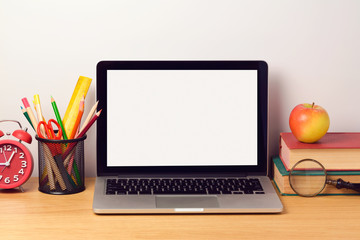 Back to school background with laptop computer and books. Modern workplace concept