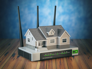 Leinwandbilder - Home wireless network. House and wi-fi router on wooden table and blue background.
