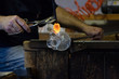 The antique art of blowing glass in Murano, Italy. Craftsman making his job.