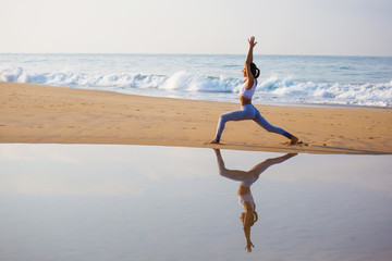 Canvas Print - Caucasian woman practicing yoga at seashore of tropic ocean