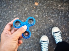 Selfie Of Fidget Spinner On Hand With Shoes