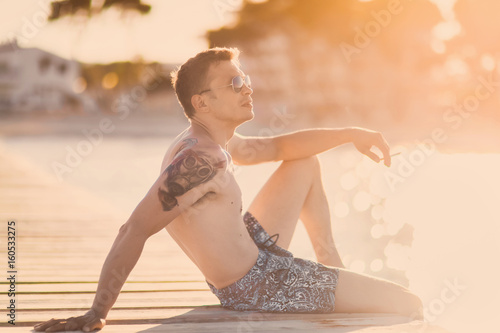 Portrait Of A Beautiful Young Sexy Slender Man In Sunglasses Against The Background Of The Island Of Palma De Moyorka Spain At Sunset Stock Photo Adobe Stock