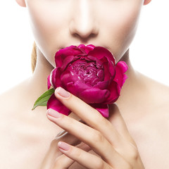 Hands with flower and part of girl face with clean skin and natural make-up over white background