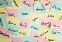 Closeup Of Paper Stickers With Different Names On White Wall. Concept Of Choosing Baby Name