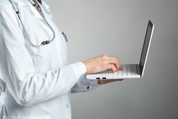 Wall Mural - Hands of medical doctor woman with laptop