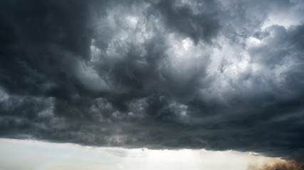 Wall Mural - clouds with background,sunlight through very dark clouds background of dark storm clouds,black sky b