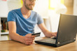 © cherryandbees - online shopping. Man using his credit card for online shopping