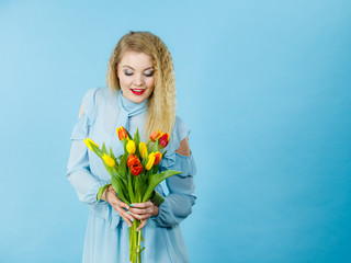 Pretty woman with red yellow tulips bunch