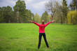 © Елена Кравчук - Woman standing back full lenght in green fresh park with hands up, copy space, space, nature